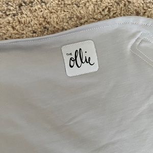 The Ollie Swaddle in Stone color + white laundry bag